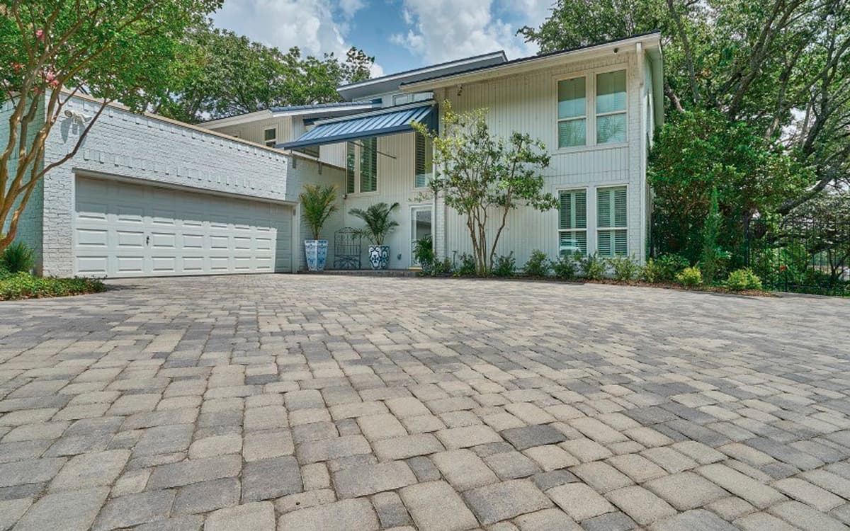 modern home with wide stone paver driveway designed by Expert Hardscaping in Fort Worth, TX